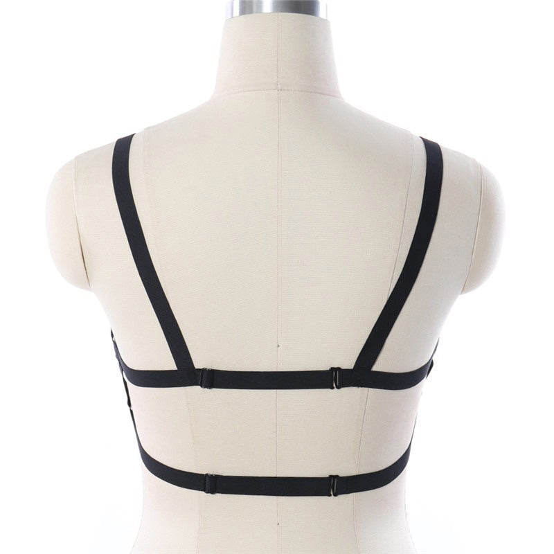 Back view of black pentagram harness lingerie on mannequin showing adjustable straps and elasticated fit.