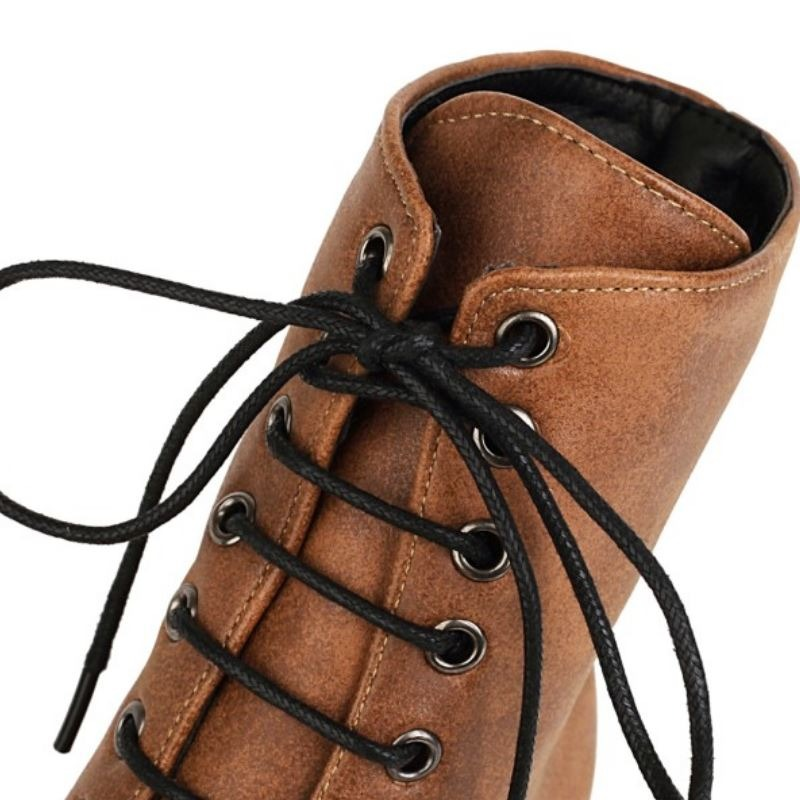 Close-up of stylish brown ankle boot with laces, featuring a modern design for fashionable women's footwear.