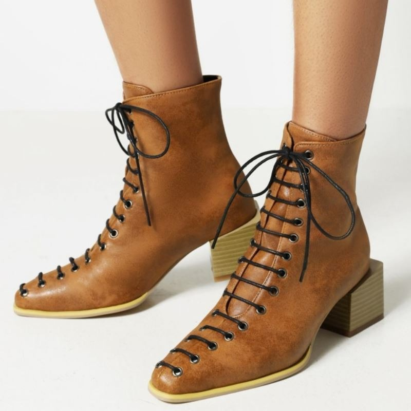 Stylish brown ankle boots for women featuring lace-up design and thick block heels, perfect for fashion-forward footwear.