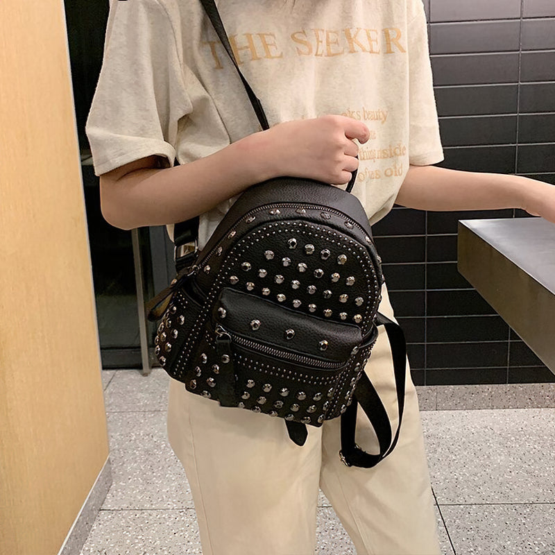 Stylish black casual backpack for women with rivet details, perfect for a goth look.