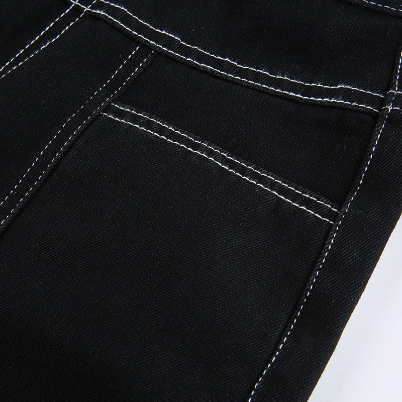Close-up of black high waist trousers showcasing white stitching and pocket details, perfect for goth or rock outfits.