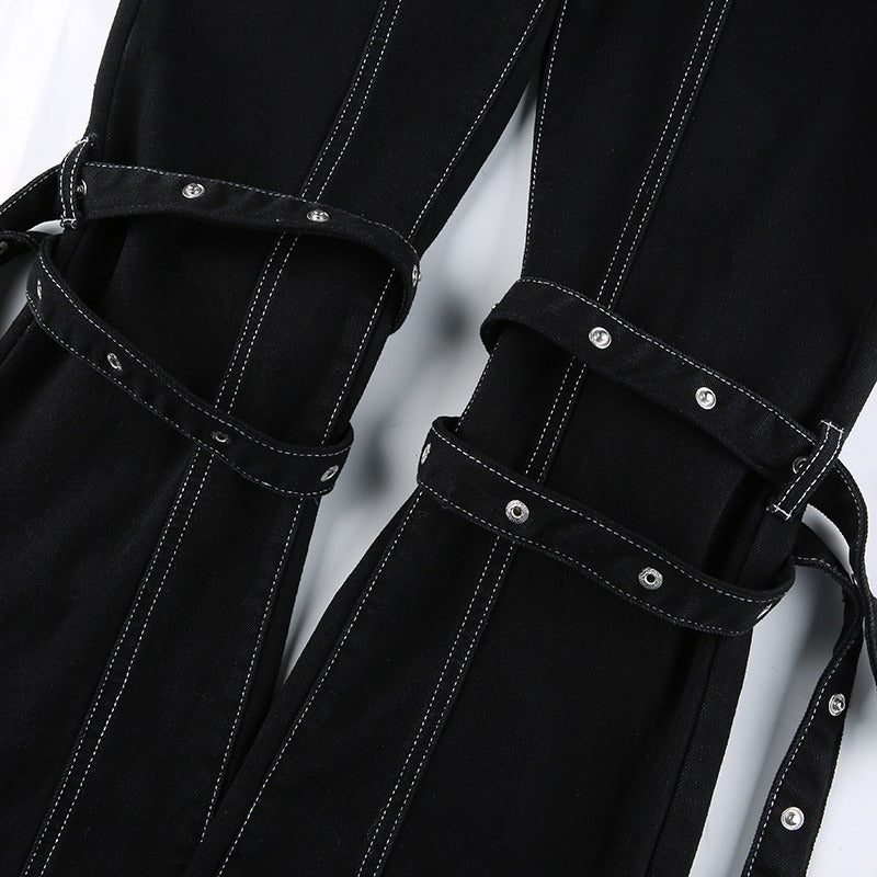 Close-up of women's black high waist trousers with zippers and stylish straps, perfect for Gothic and rave outfits.