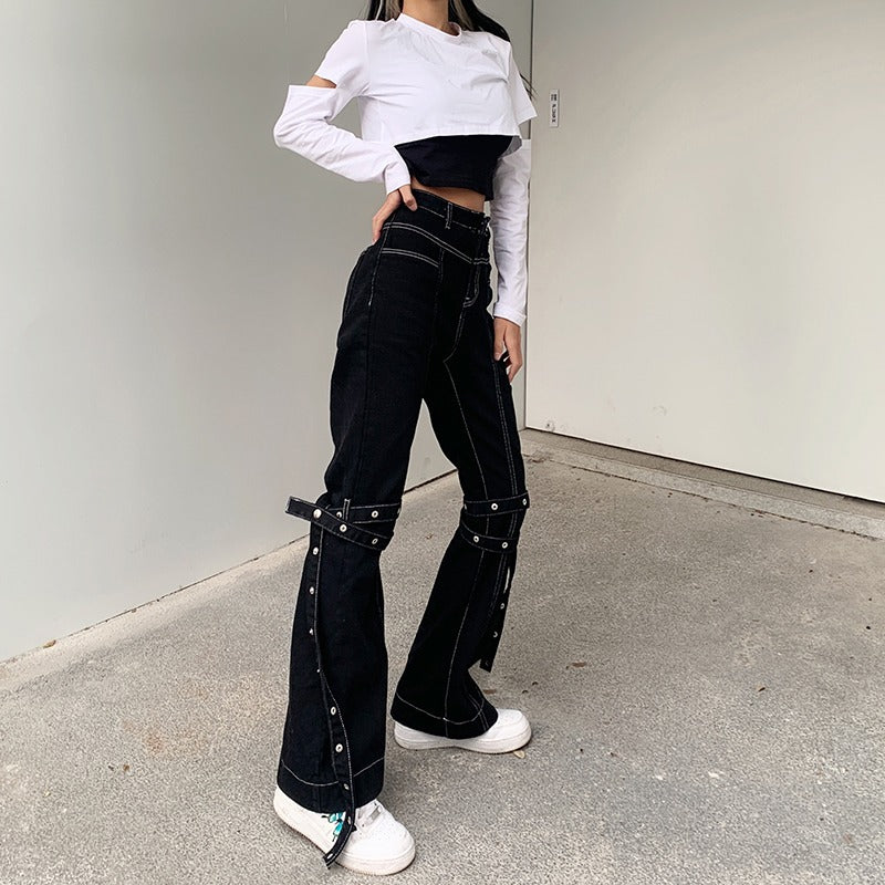Model showcasing women’s high waist black trousers with zippers and straps, styled for a chic goth outfit.