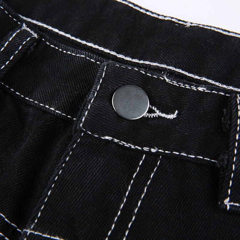 Close-up of the button and stitching detail on women’s high waist black rivet trousers for a stylish gothic look.
