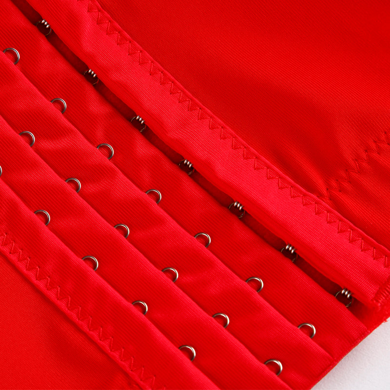 Close-up of red PU leather corset detailing with metal eyelets and stitching for women in gothic style.