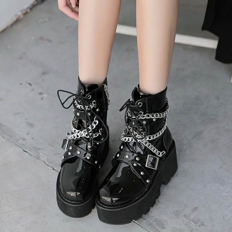 Stylish women's black PU leather boots with chains and rivets, featuring a trendy square heel and short plush lining.