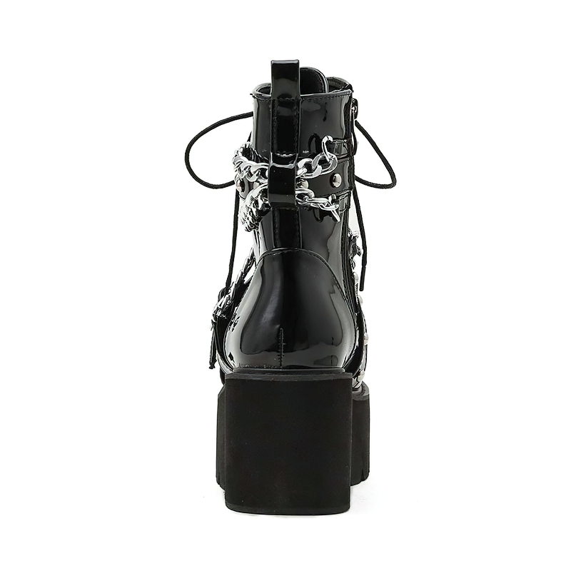 Back view of women's stylish black boots with chain and rivets, featuring a square heel and plush interior.
