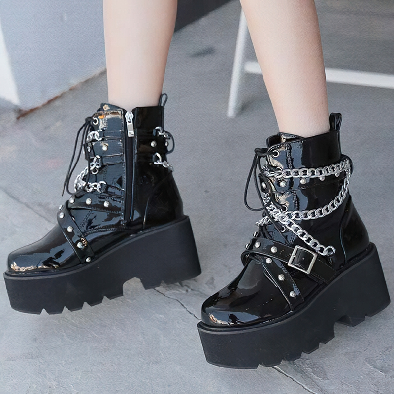 Stylish women's black PU leather boots with chain and rivets, featuring high platform soles and a rock design.