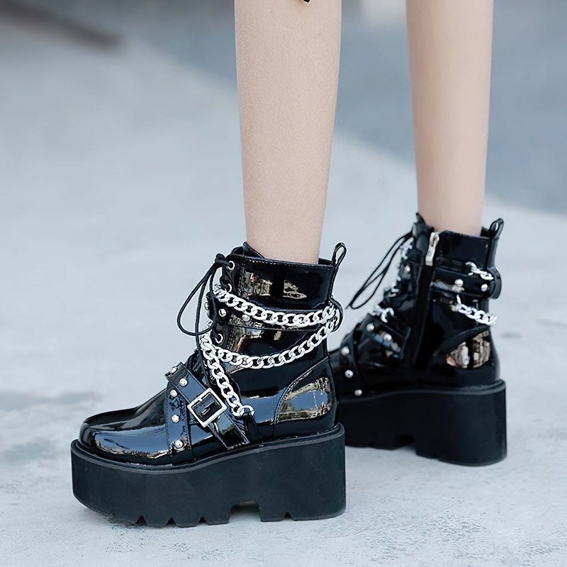 Stylish women's black boots with chain and rivets, featuring a high platform sole and short plush interior.