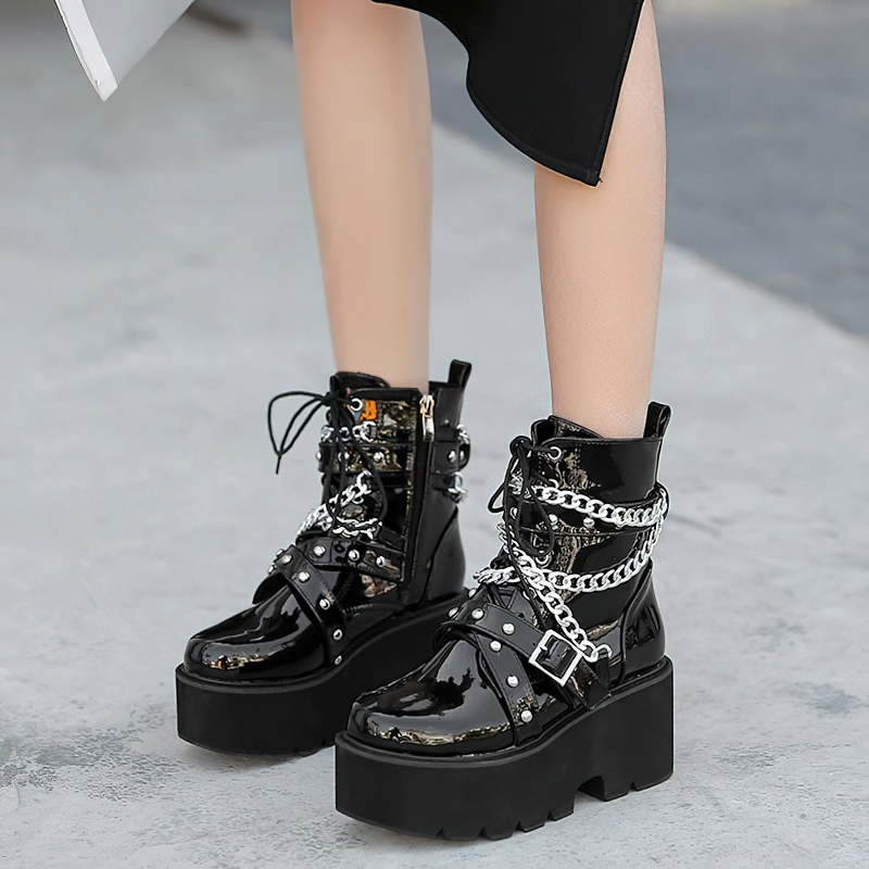 Trendy women's black PU leather boots with chains, rivets, and square heels, offering a stylish rock look and plush interior.