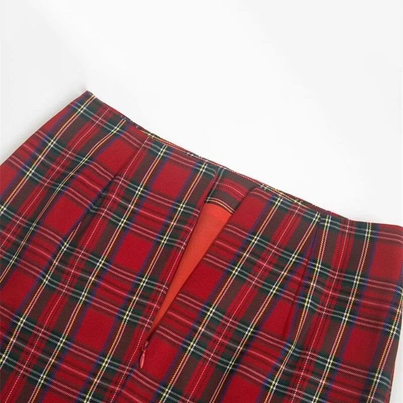 Red plaid pencil skirt zoomed in on zipper detail and pleats, perfect for a stylish grunge look.