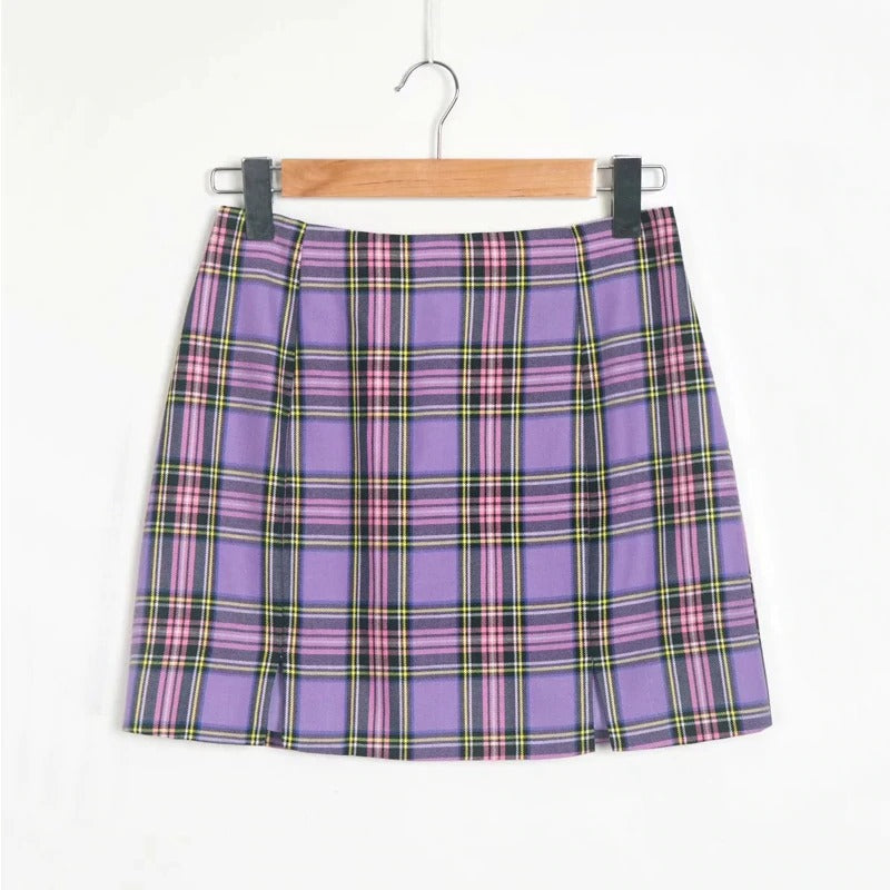 Purple plaid pencil skirt with two small front slits hanging on a wooden hanger