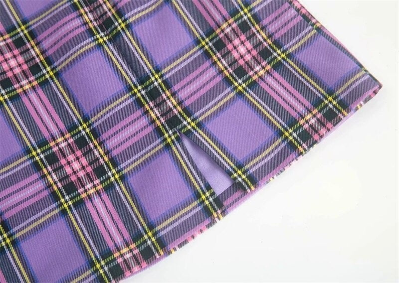 Close-up of purple plaid pencil skirt with two small front slits and stylish pattern, perfect for a grunge look.