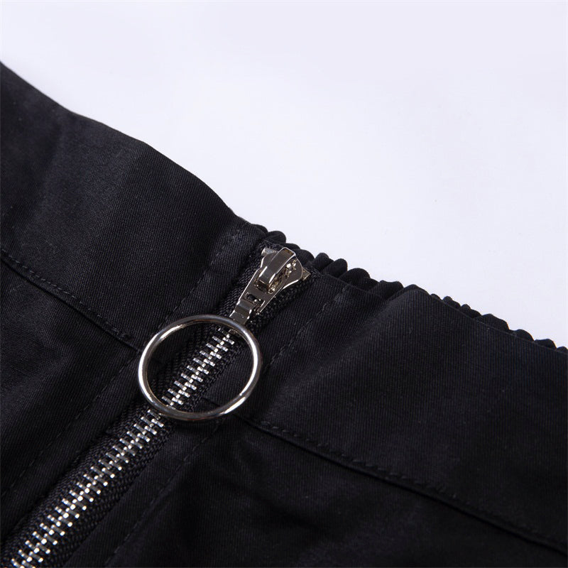 Close-up of solid black zipper on Gothic streetwear pants with a chain detail, showcasing stylish design.