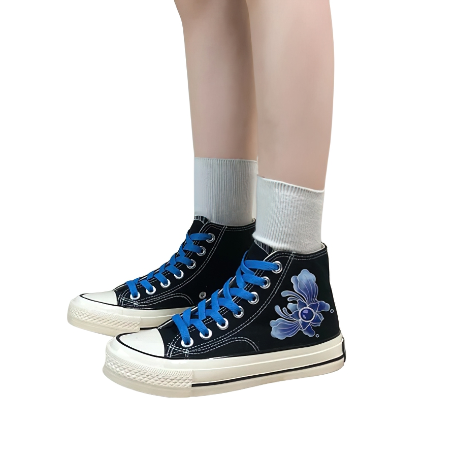 Stylish women's aesthetic sneakers with blue graffiti on black canvas, perfect for casual outings.