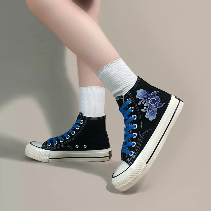 Stylish black canvas sneakers with blue laces and floral graffiti design, perfect for casual outings.