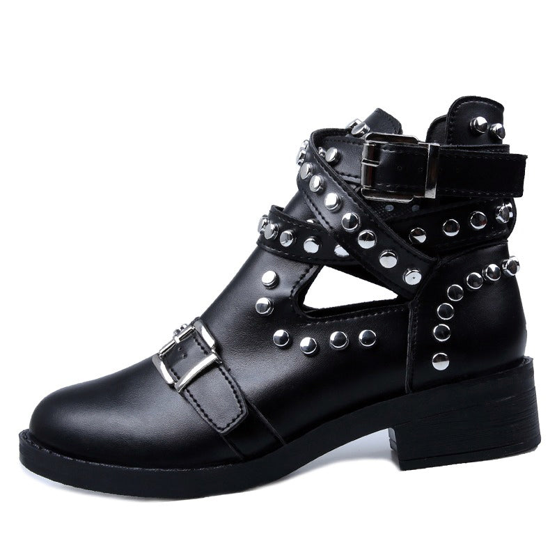 Women's black leather ankle boots with rivets and buckle strap, perfect for a rock style outfit.