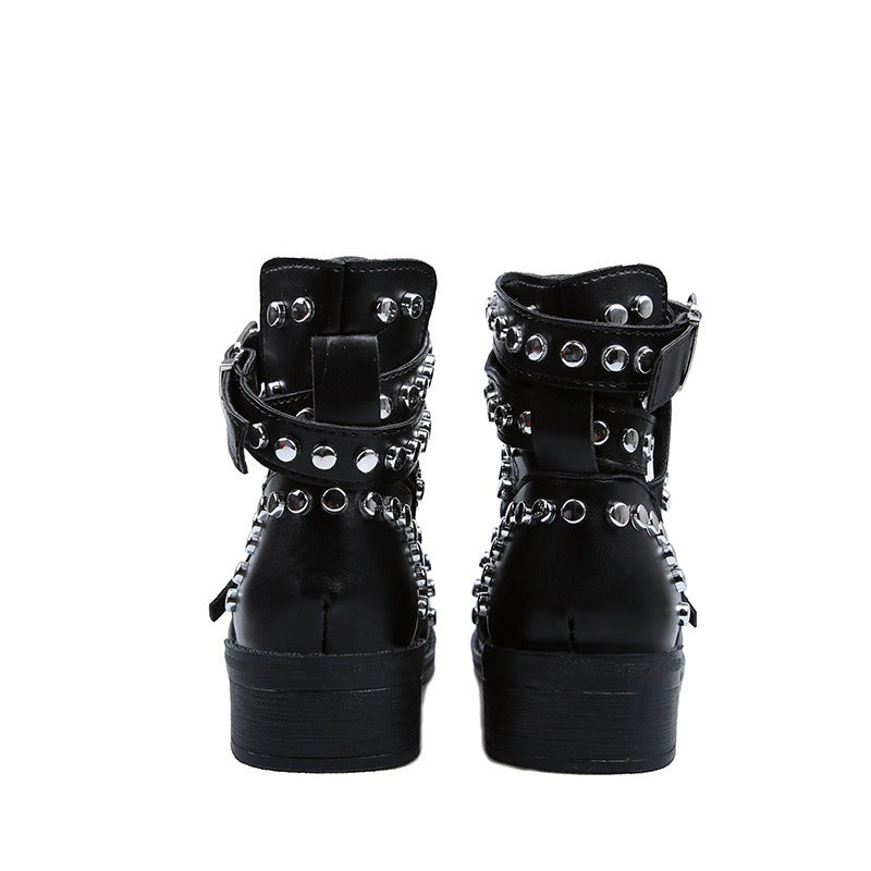 Back view of women's black ankle boots with rivets and leather buckle straps, perfect for a rock fashion style.