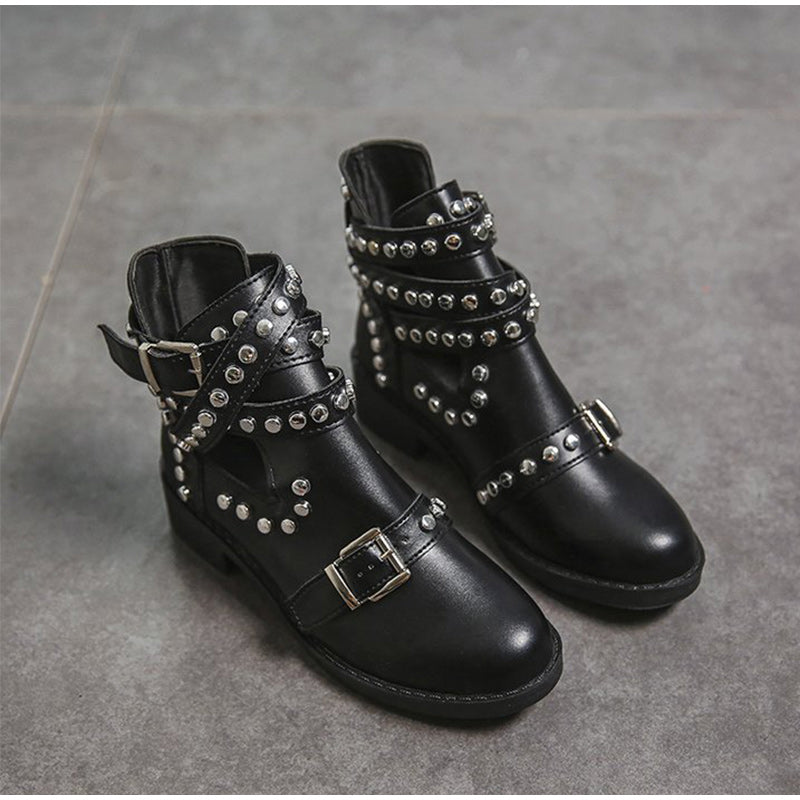 Women's black leather ankle boots with rivets and buckle straps, perfect for a stylish rock look.