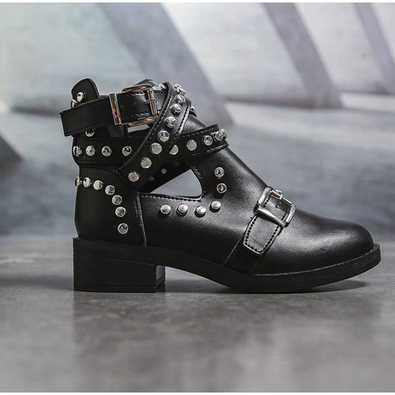 Women's black ankle boots with rivets and buckle straps, perfect for rock-inspired fashion.