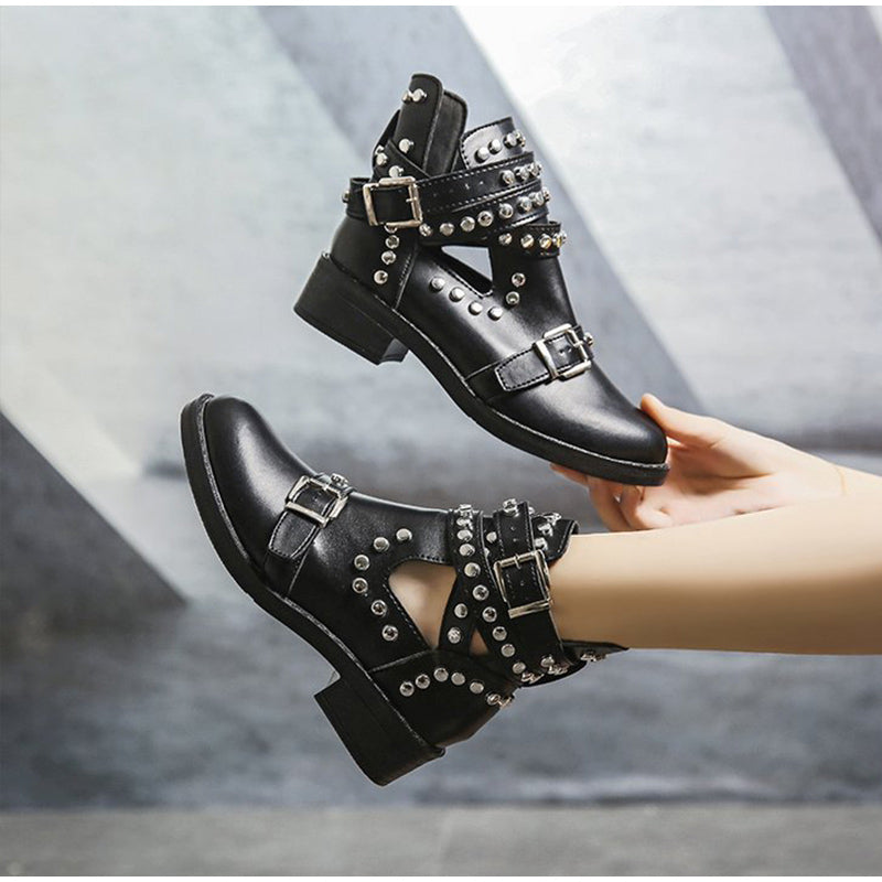 Stylish women's black ankle boots featuring rivets and buckles, perfect for a bold rock fashion statement.