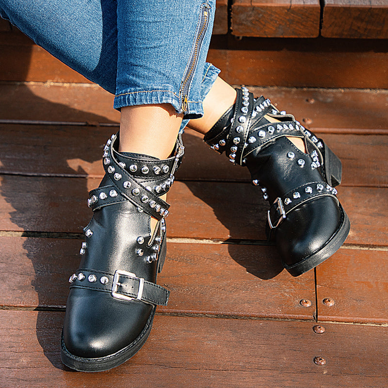 Stylish women's black ankle boots with rivets and buckle straps, perfect for a rock look.