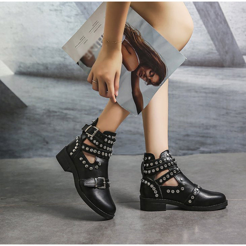 Women's black leather ankle boots with rivets and buckle strap, perfect for a stylish rock look.