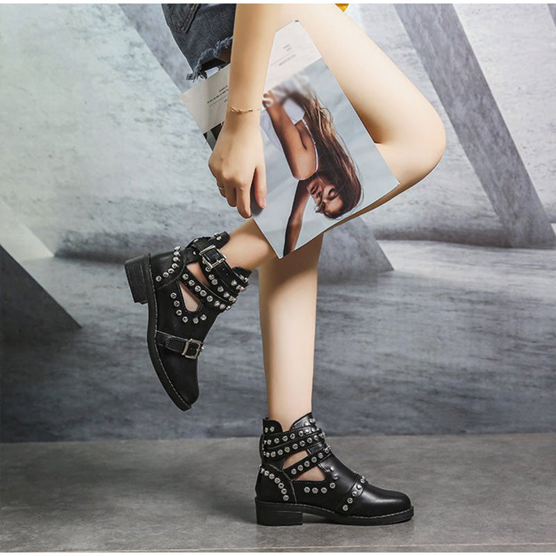 Stylish women's leather ankle boots with rivets and buckles, perfect for a rock-chic look.