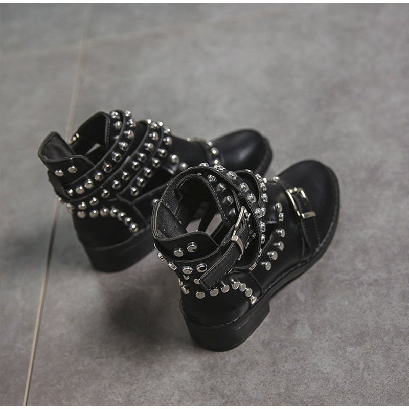 Fashionable women's black ankle boots with rivets and buckles, perfect for a chic rock style.