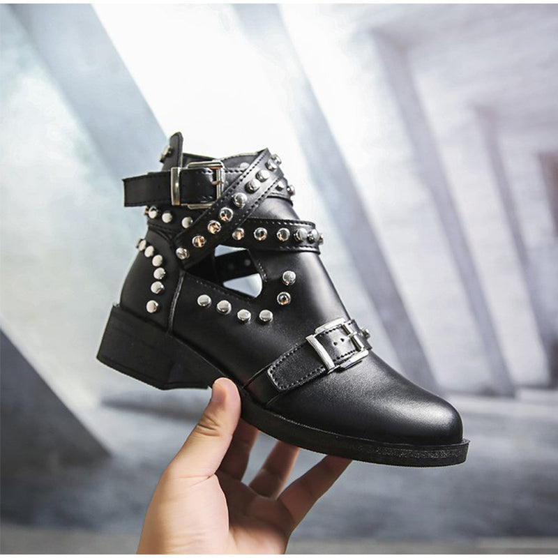 Stylish women's black ankle boots featuring rivet details and leather buckle strap, perfect for a rock-inspired look.