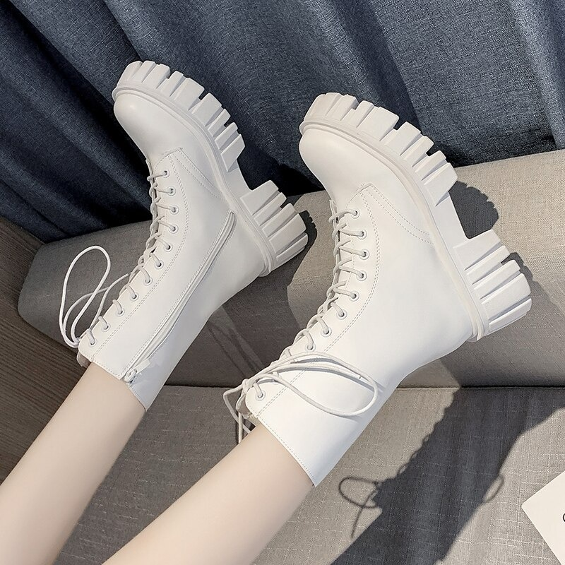White lace-up ankle boots with chunky platform sole, perfect for a casual and stylish look.