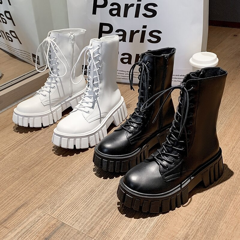 Stylish women's ankle boots in black and white with lace-up design and platform soles, perfect for casual wear.