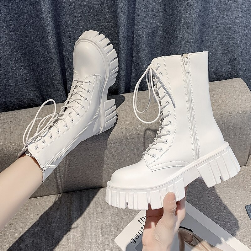 Stylish women's white ankle boots with lace-up design and chunky platform heels, perfect for any casual outfit.