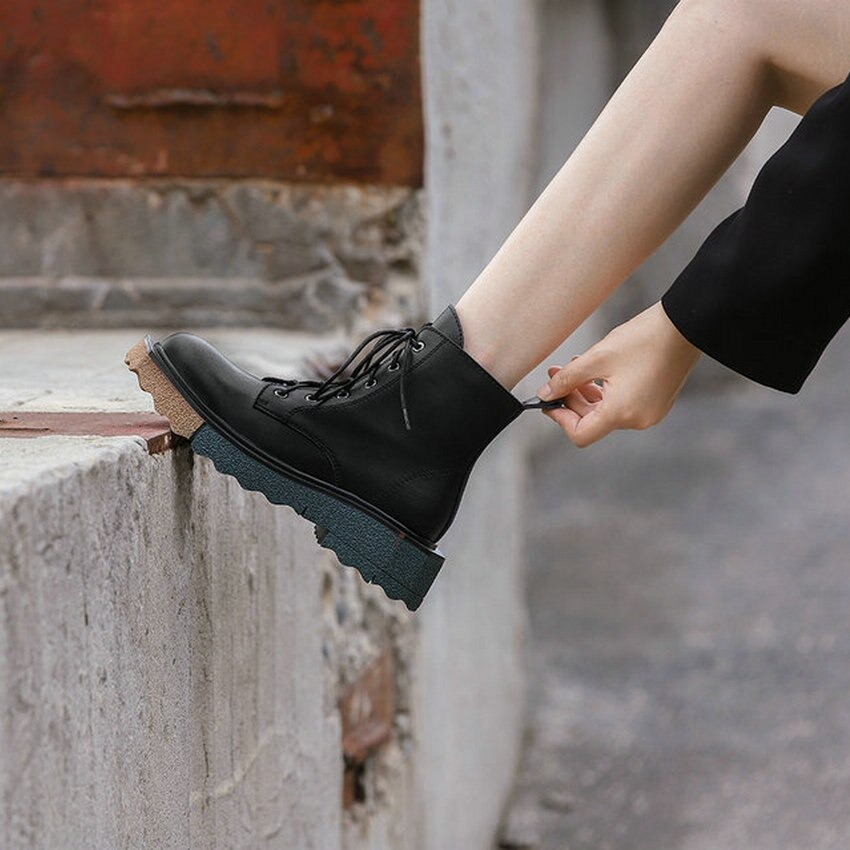 Stylish women's leather ankle boots with lace-up design and chunky sole, perfect for trendy casual outfits.