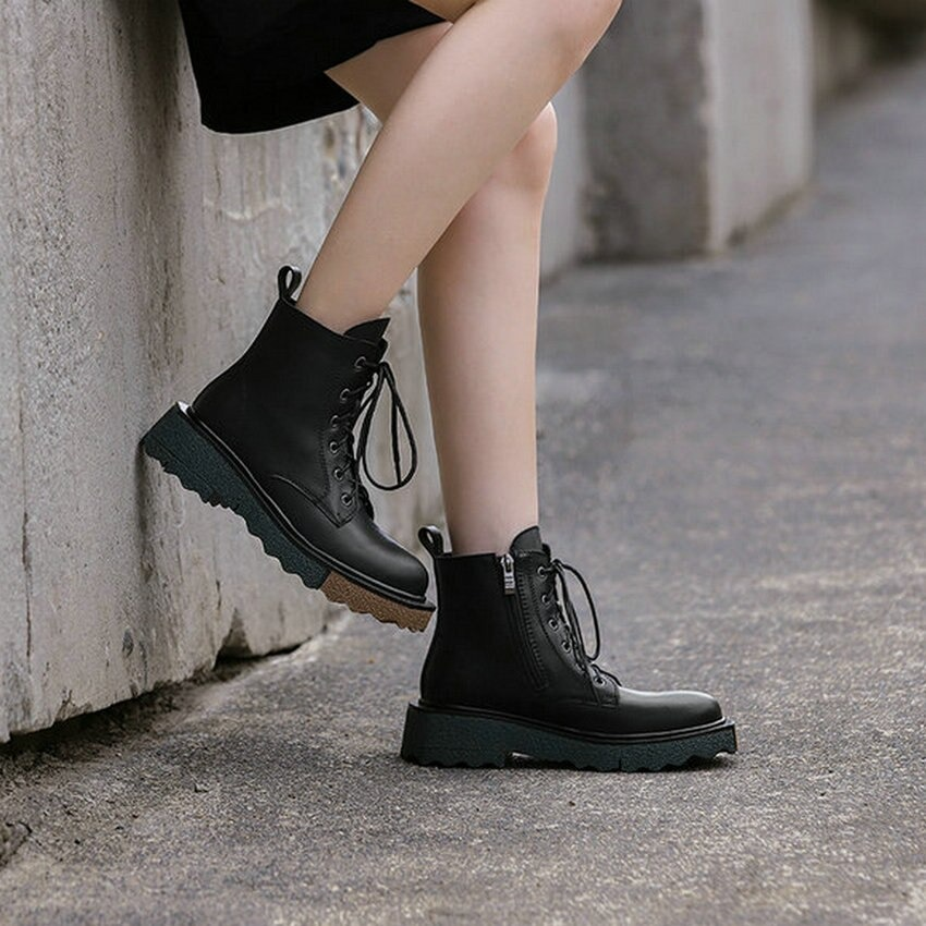 Stylish women's real leather ankle boots with laces and durable sole in black, perfect for trendy outfits.
