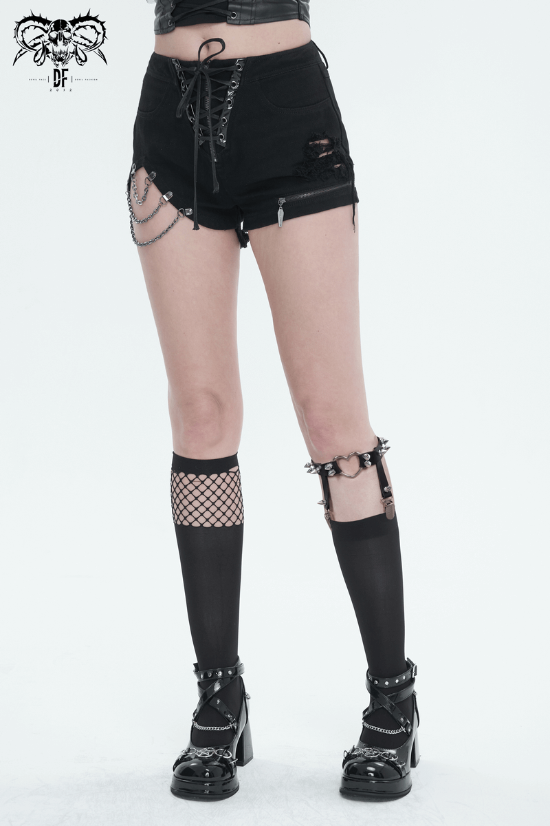 Bold fashion scene: model in black shorts and edgy knee-length socks with garters, showcasing punk style.