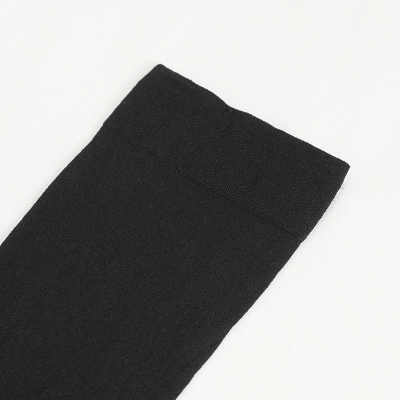 Close-up of black women's knee-length sock with an asymmetrical design and textured top.