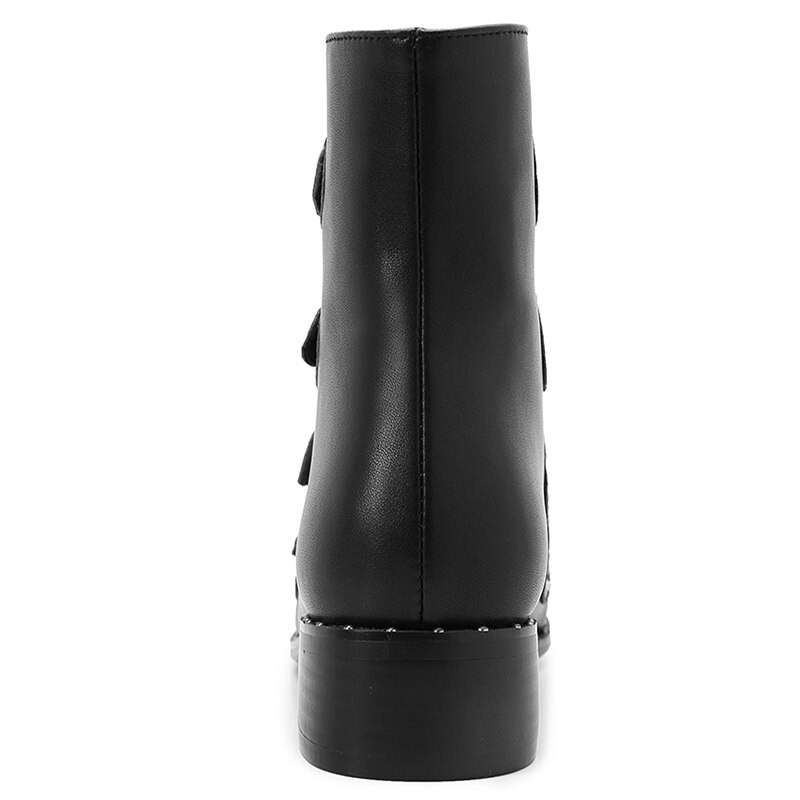 Back view of women's black ankle boots with low heel and metal rivets, perfect for autumn and winter outfits.