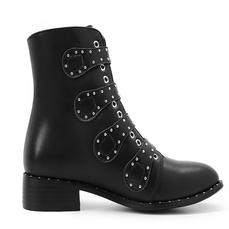 Women's black ankle boots with low heel, metal rivets, and decorative zippers for a stylish rock look.