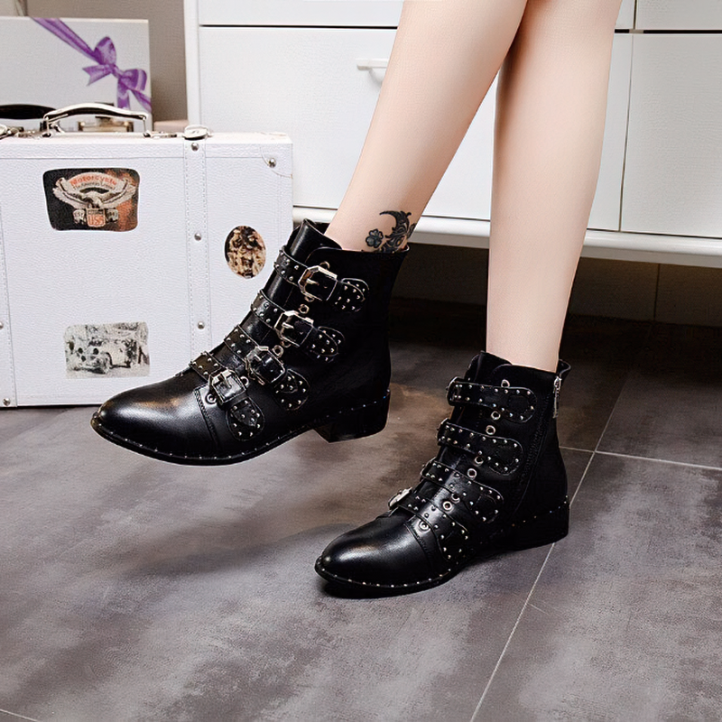 Stylish women's low heel ankle boots with metal rivets and buckles, perfect for a chic autumn look.