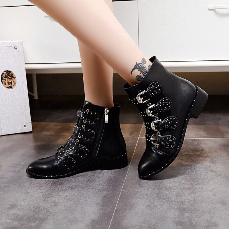 Stylish women's black ankle boots with metal rivets and low heel, perfect for autumn and winter fashion.
