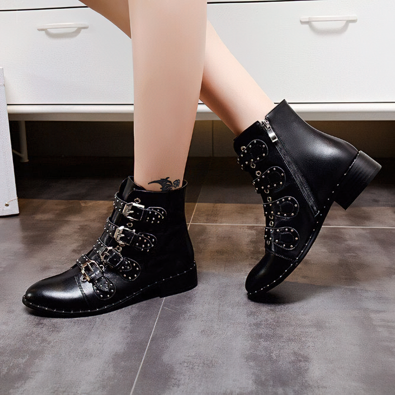 Stylish women's black ankle boots with low heel and metal rivets, perfect for autumn and winter fashion.