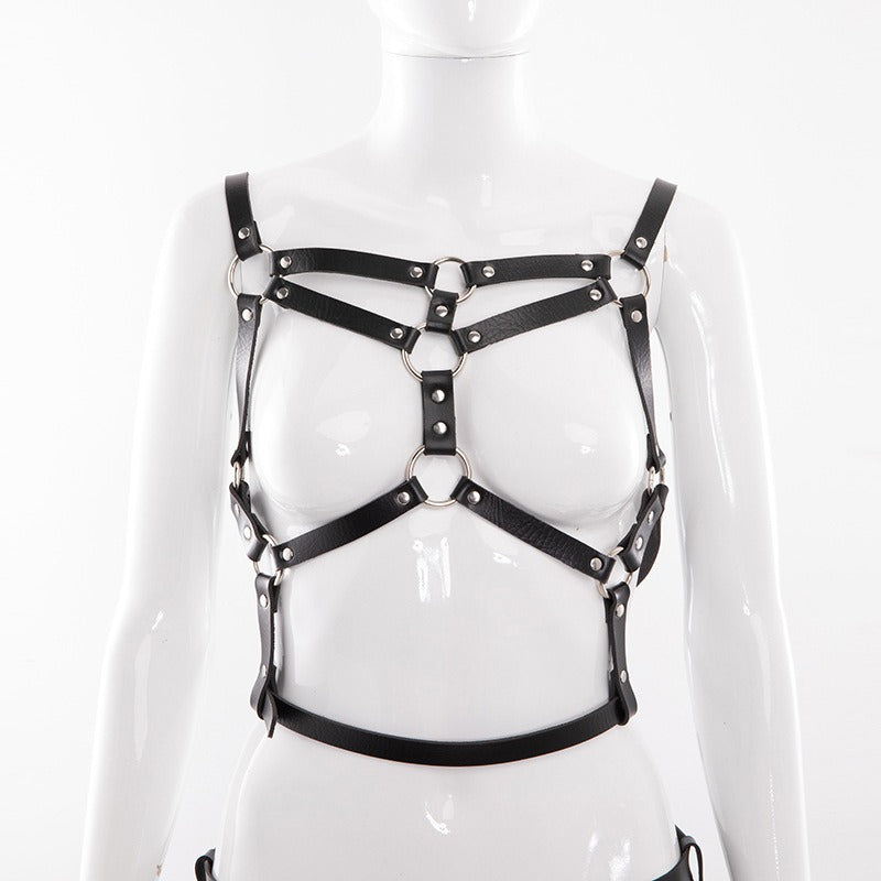 Women's adjustable faux leather harness belt with metal accents for stockings and body bondage.