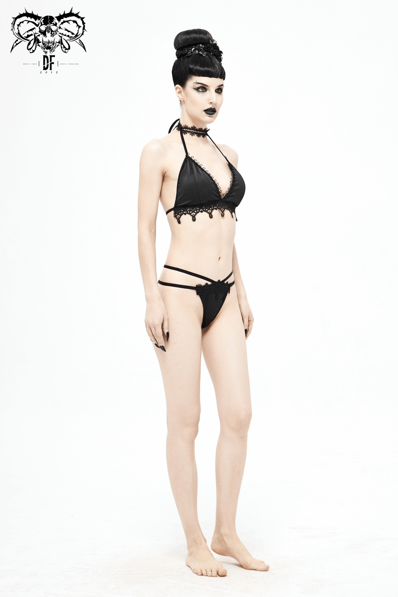 Elegant model showcasing a women's black bikini with choker and gothic lace details on a minimalist backdrop.