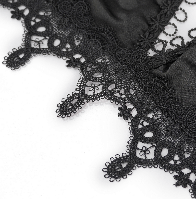 Close-up of intricate black lace trim on a gothic swimsuit, showcasing elegant patterns and textures.