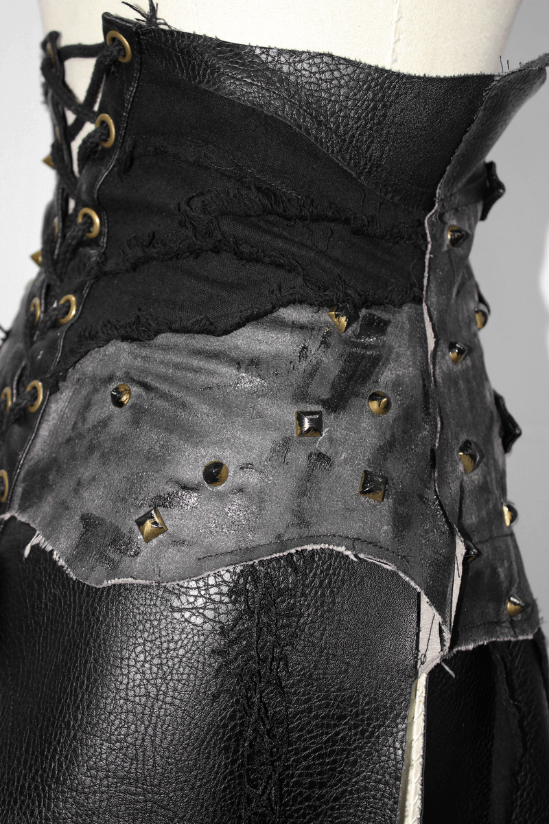 Close-up of women's black corset half skirt with lace-up detail and studs, featuring a punk retro style.