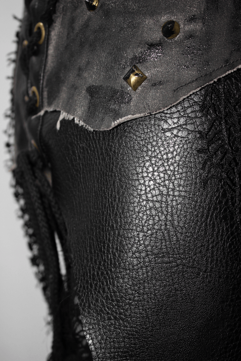 Close-up of women's black corset half skirt featuring lace-up details and stylish studs.