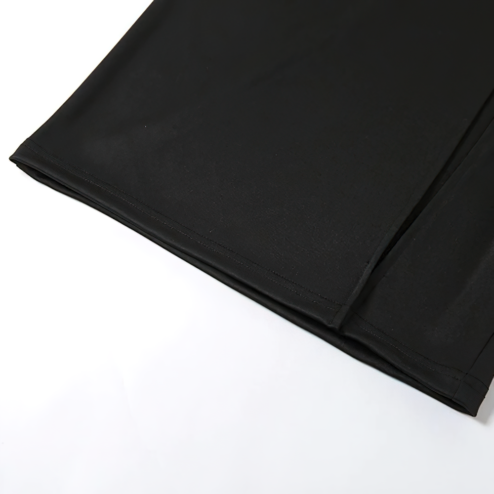 Women's black gothic punk midi skirt showing sleek design and side slits, perfect for a trendy aesthetic.