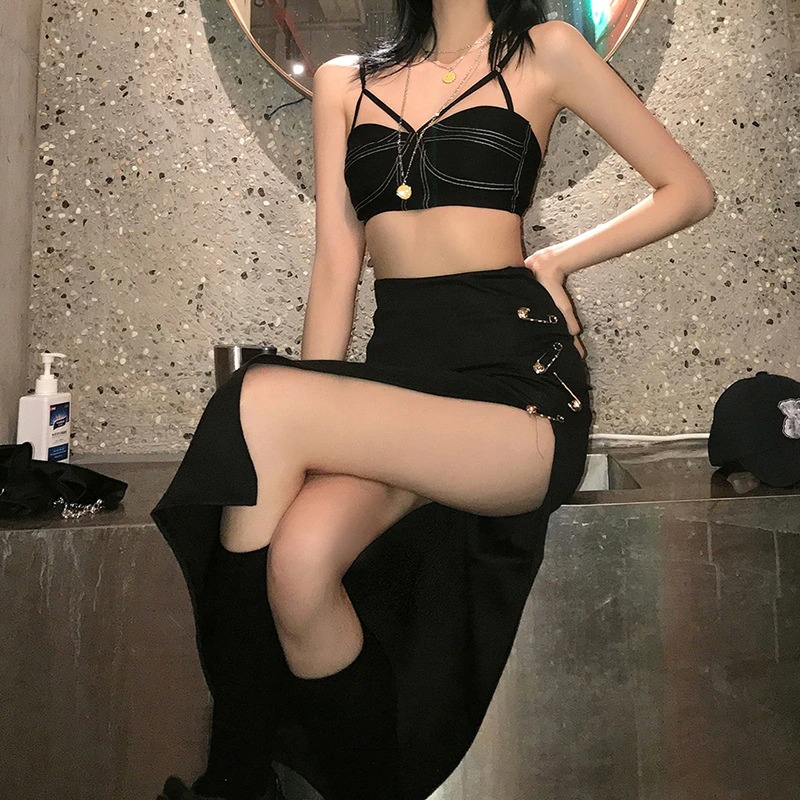 Model showcasing a women's black gothic punk split midi skirt paired with a stylish crop top in an aesthetic setting.