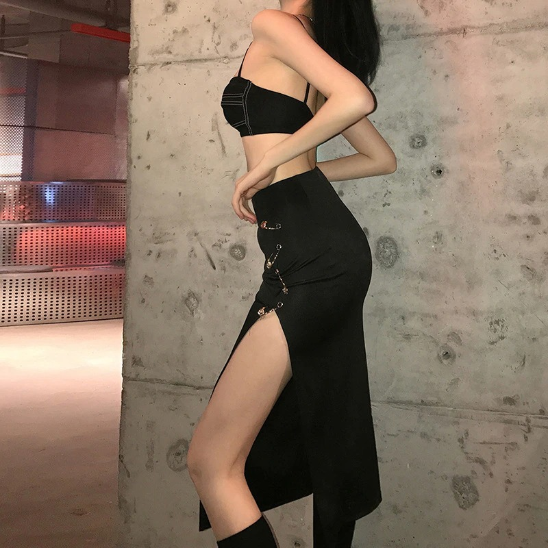 Model showcasing a women's black gothic punk split midi skirt with high waist and decorative pins.